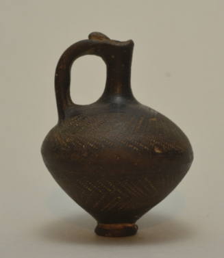 Jug of black ware ornamented with herringbone dotted pattern