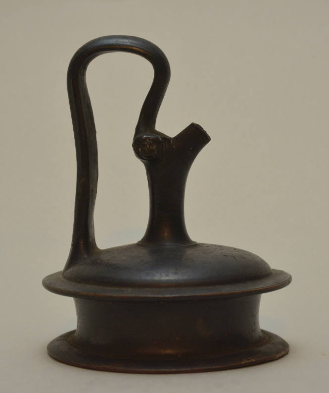 Black-glazed pottery epichysis with high-arched handle, and stamped palmettes around shoulder