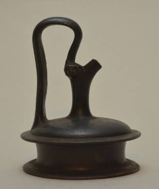 Black-glazed pottery epichysis with high-arched handle, and stamped palmettes around shoulder