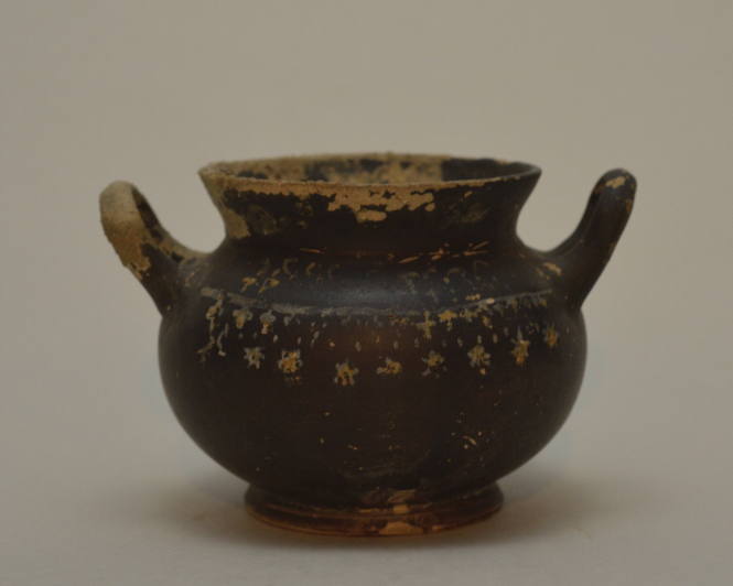 Gnathian black-glazed twin-handled jar with traces of painted decoration around shoulder