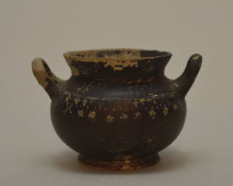 Gnathian black-glazed twin-handled jar with traces of painted decoration around shoulder