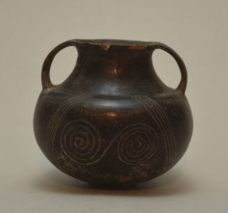 Villanovan double-sided handled jar; incised with double spirals on both sides, flanked by parallel zig-zag lines