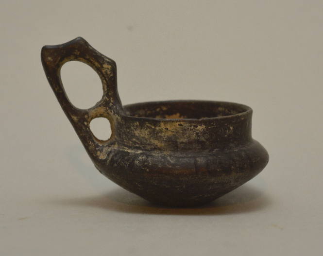 Etruscan (?) bucchero shallow cup, with high "double handle" and ribbed shoulder