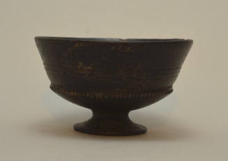 Etruscan bucchero "chalice" on low fot, with three incised encircling bands, and a band of notched ridges