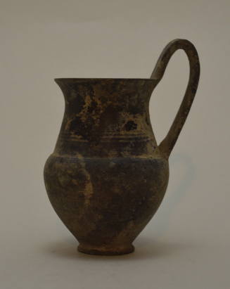 Etruscan bucchero jug, with strap handle and incised lines encircling the neck