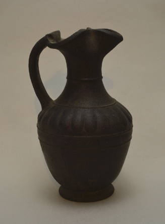 Etruscan Bucchero oinochoe with trefoil lip and moulded tongues on shoulder