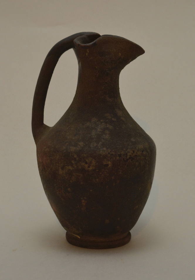 Black-glazed oinochoe with trefoil spout and cylindrical handle