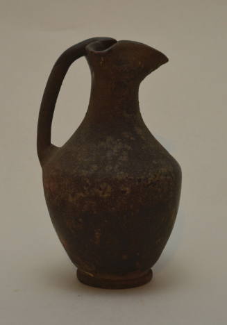Black-glazed oinochoe with trefoil spout and cylindrical handle