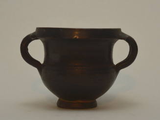 Black-glazed kantharos with twin double handles and overhanging rim