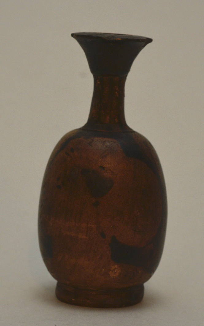 Red-figure squat lekythos with female head