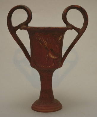 Apulian red-figure kantharos, with narrow stem and high handles painted with profile female heads
