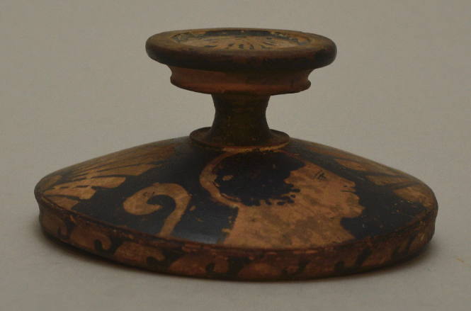 South ITalian red-figure lekanis lid; painted with profile heads and palmettes