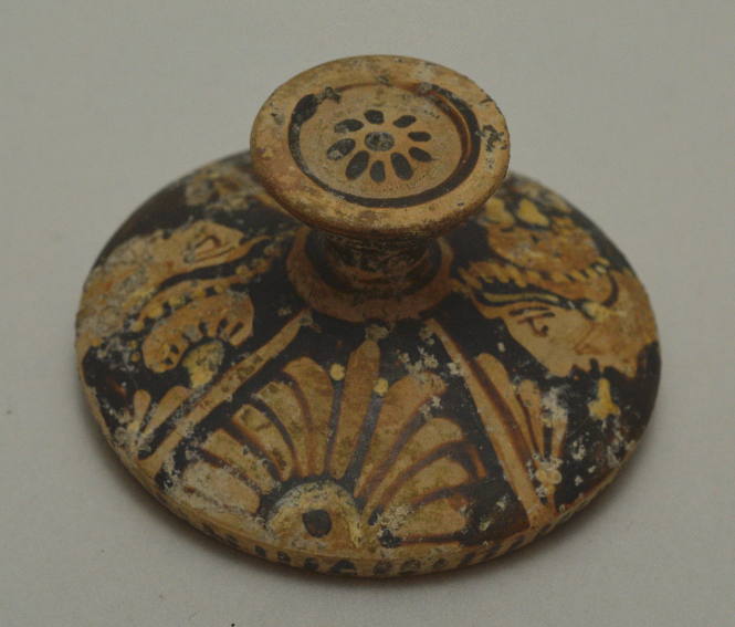 South Italian red-figure lekanis lid; painted with profile heads and palmettes