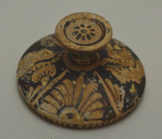 South Italian red-figure lekanis lid; painted with profile heads and palmettes