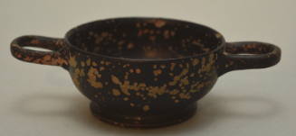 Black-glaze miniature kylix; four radical palmetts in interior