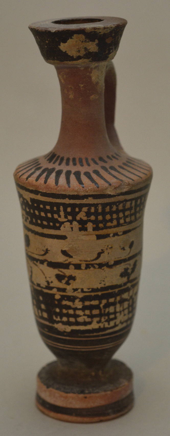 Attic black-figure lekythos ornamented with ivy wreath and crossbars, rays on shoulder