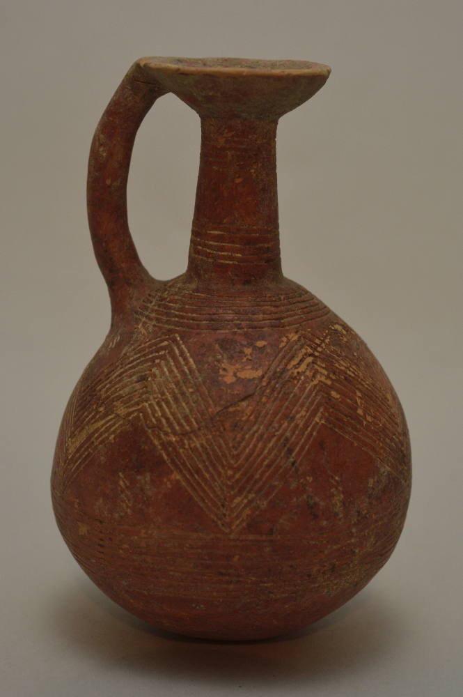 Cypriot red polished-ware jug; incised with parallel zig-zag ornament and encircling bands