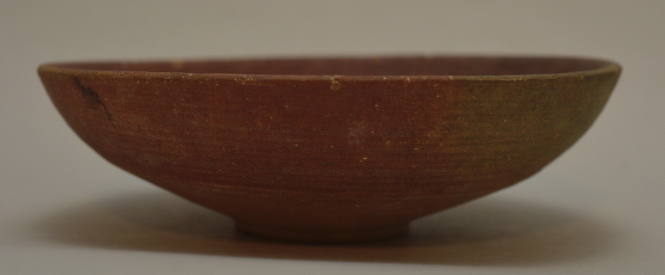 Shallow bowl on ring foot; red banded decoration on exterior