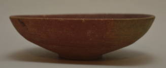 Shallow bowl on ring foot; red banded decoration on exterior