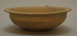 Buffware bowl with everted lip; rim pierce for suspension