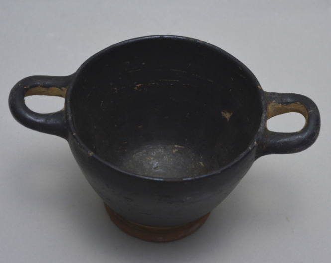 Black-glazed skyphos; reserved band around foot