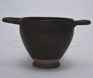 Black-glazed skyphos with horizontal handles; reserved band at base