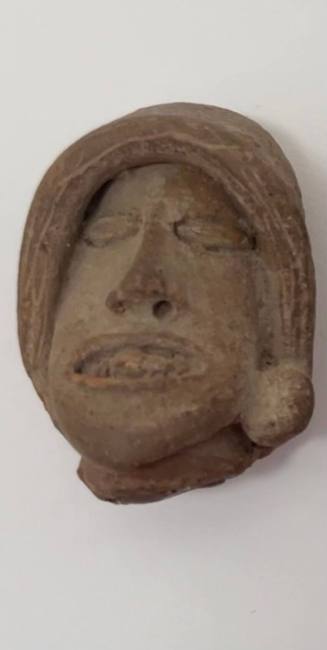 Small head of a man, wearing incised hood