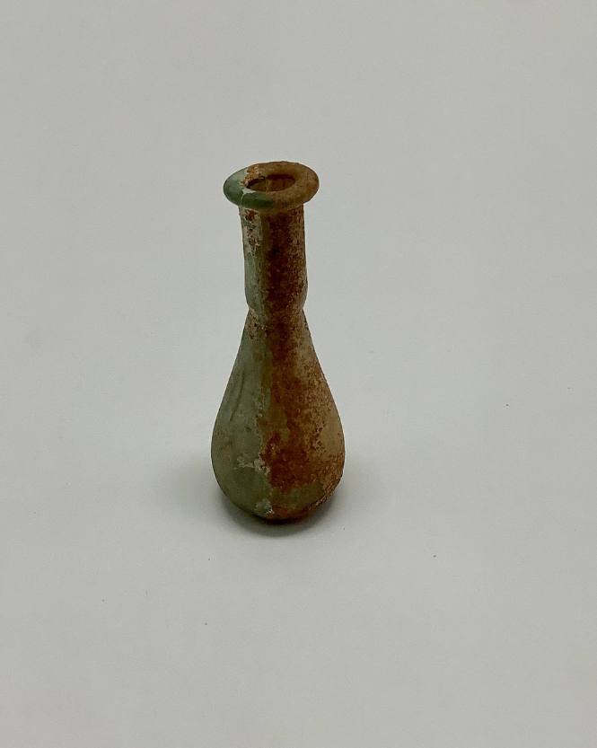 Roman unguentarium with constriction between body and neck; folded rim