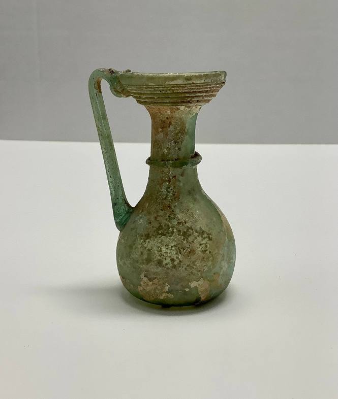 Funnel-mouthed jug, with concave base, thread decoration below rim and around hamdle; thread handle
