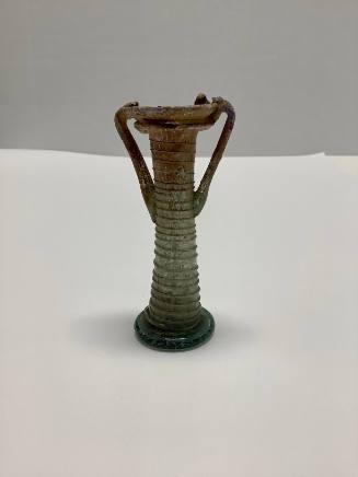 Roman Balsamarium with two handles and horizontal ribbing on neck; trailed spiral thread decoration around body