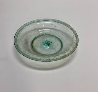 Shallow dish with rounded rim and raised dome in the center of the bottom