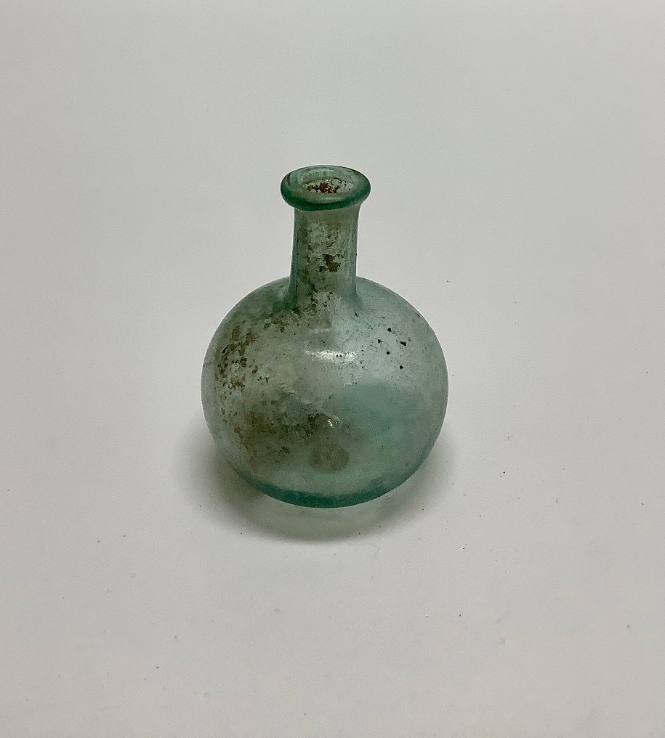Bottle with globular body concave base, rim folded in and flattened
