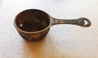 Handled bowl with incised ornament in the center and on the handle