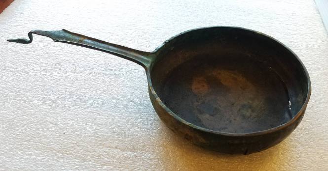 Saucepan with stylized bird at end of handle
