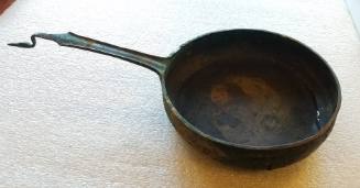 Saucepan with stylized bird at end of handle