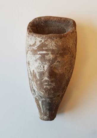 Lamp in the form of a head emerging from a blossom