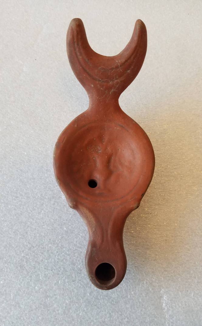 Lamp with fishtail-shaped handle and relief of vase