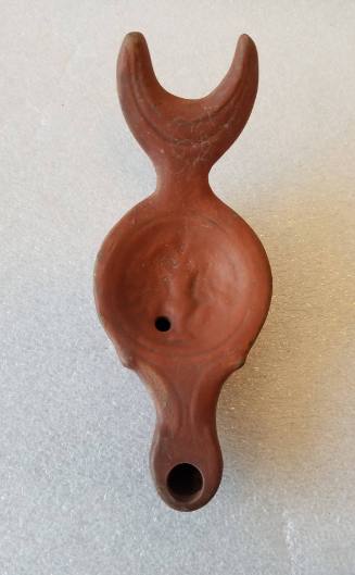 Lamp with fishtail-shaped handle and relief of vase