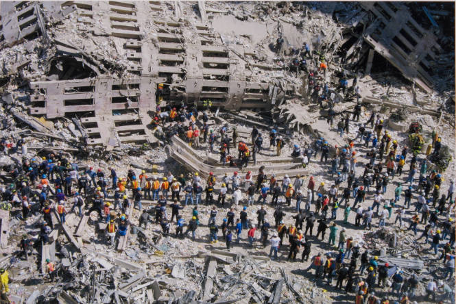[Rescue workers in wreckage, from above]