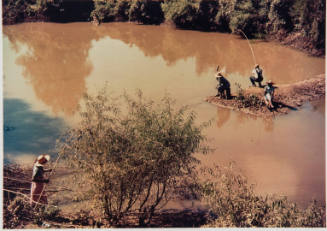 Negroes fishing in creek near cotton plantations outside Belzoni Mississippi Delta