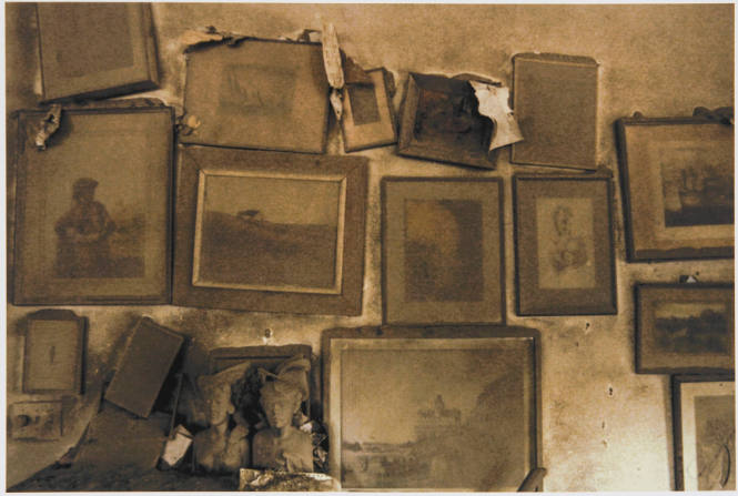 [Ash-laden pictures on a wall]