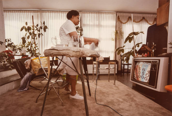Untitled [woman ironing and watching TV]
