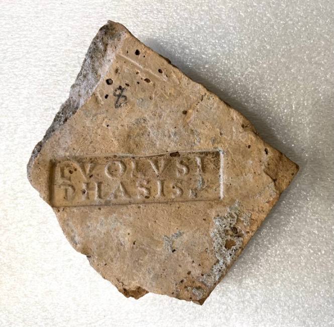Fragment with latin inscription on crescent-shaped ground