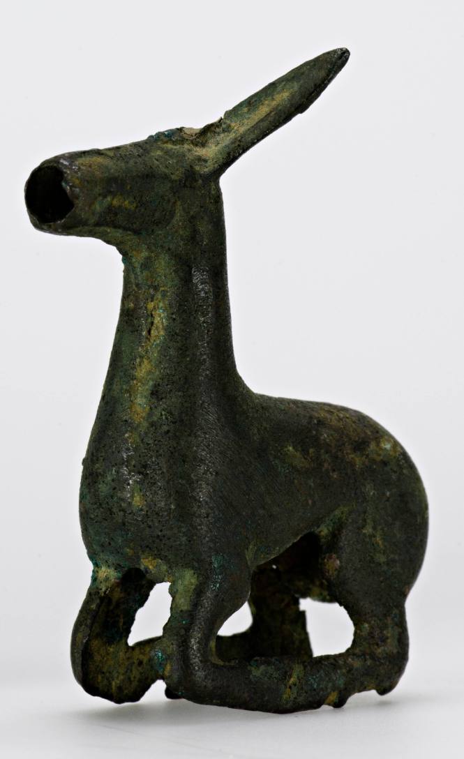 Yoke ornament of a crouching animal with head tilted back