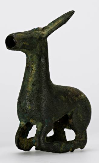 Yoke ornament of a crouching animal with head tilted back