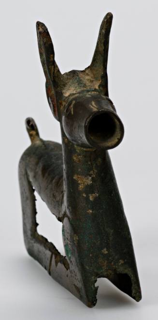 Yoke ornament of a crouching animal, with tail curling back