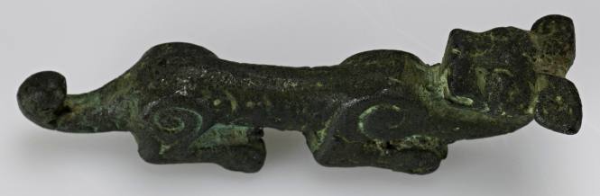 Yoke ornament of a crouching animal, with abstract surface