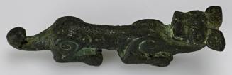 Yoke ornament of a crouching animal, with abstract surface