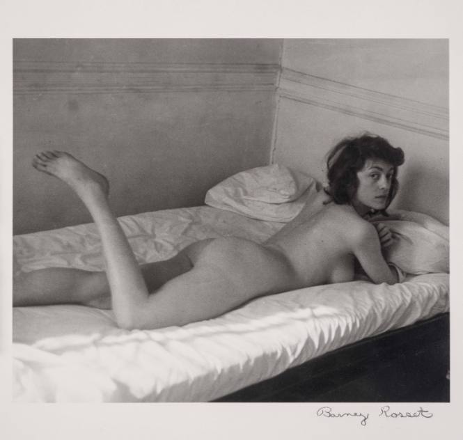 [Nude woman lounging on bed]