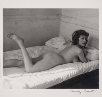 [Nude woman lounging on bed]